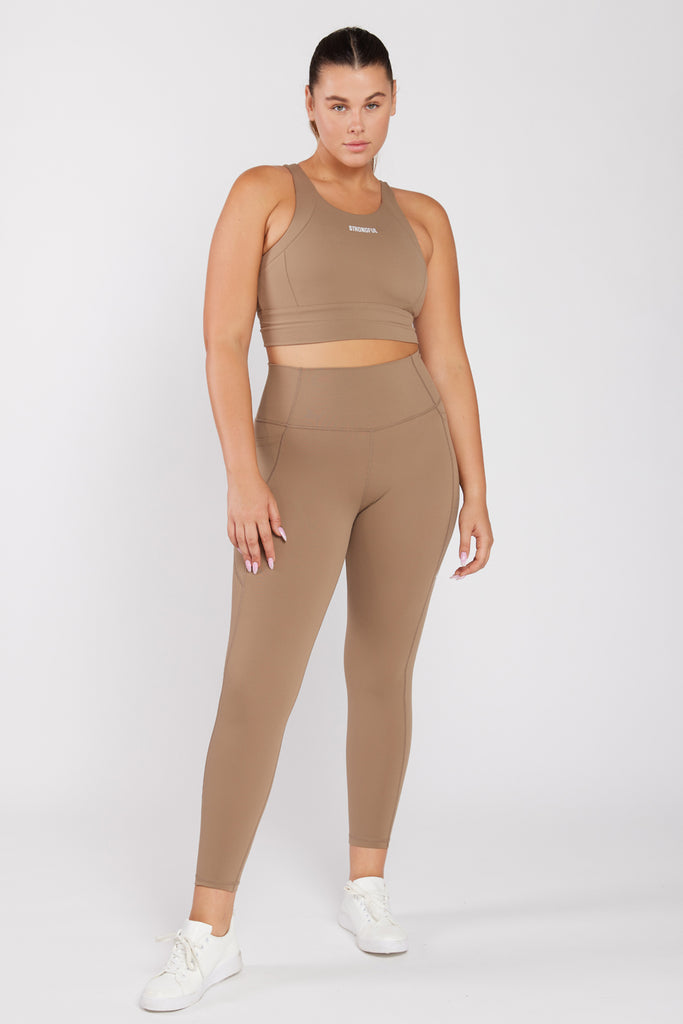 של המותג סטרונגפול Polly דוגמנית לובשת טופ | L